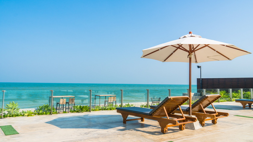 beautiful-umbrella-chair-around-swimming-pool-hotel-resort